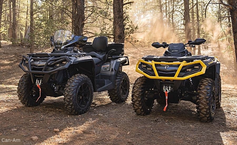 Two Can-Am ATVs Parked on a Dirt Trail in a Forest