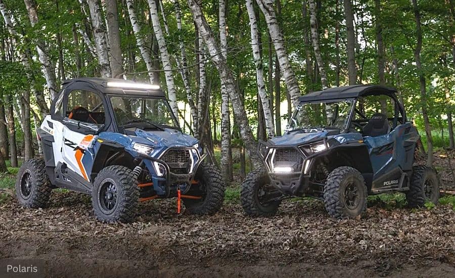 Two UTVs (Utility Terrain Vehicles) On a Trail Within a Birch Forest 