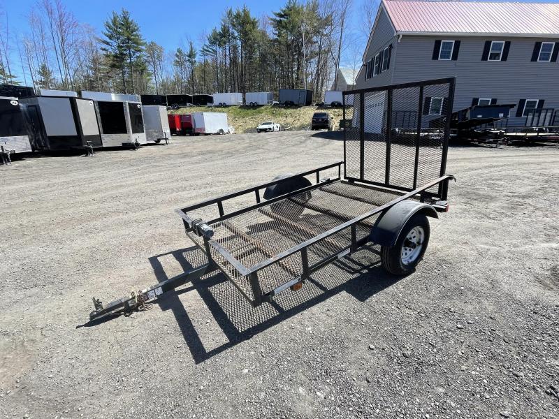 Black Mesh Utility Trailer With a Single Axle and Wheel Parked on a Gravel Surface