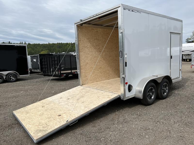 White Dual-Axle Enclosed Cargo Trailer Parked With its Rear Ramp Door Down