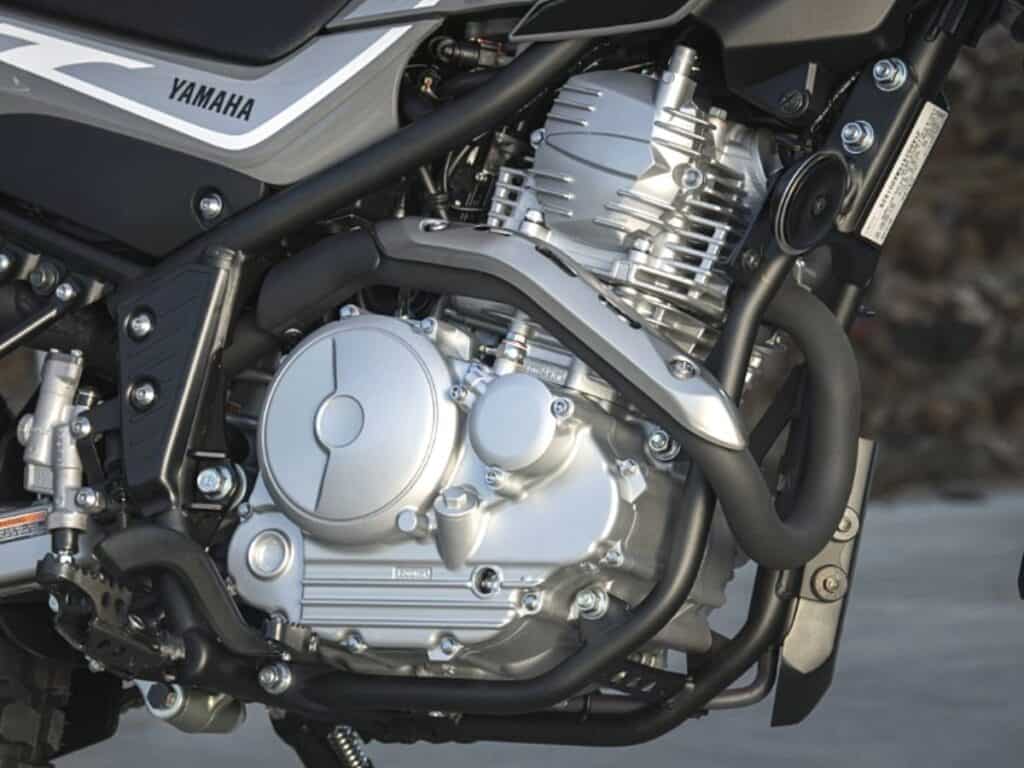 Close-up of a Yamaha Dirt Bike Engine, Showcasing the Chrome Detailing on the Cylinder Heads and Exhaust Manifold 