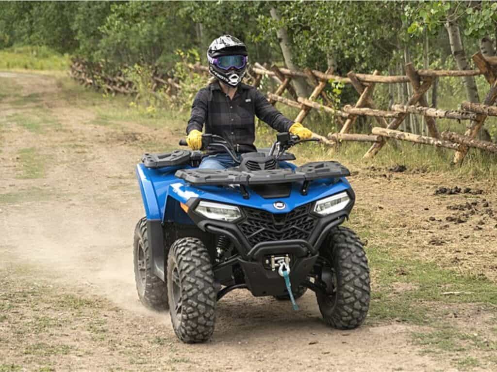 Rider on a Blue CFMoto CForce 500 ATV on a Dirt Path