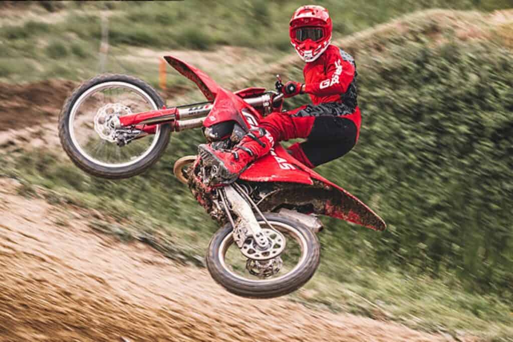 Motocross rider jumping a red GasGas MC 250 dirt bike.