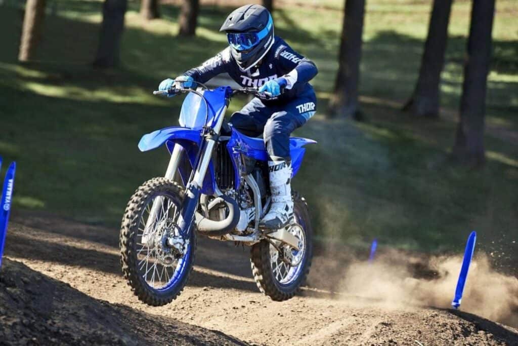 Yamaha YZ250 in the air, riden by a rider in blue and black motocross gear.