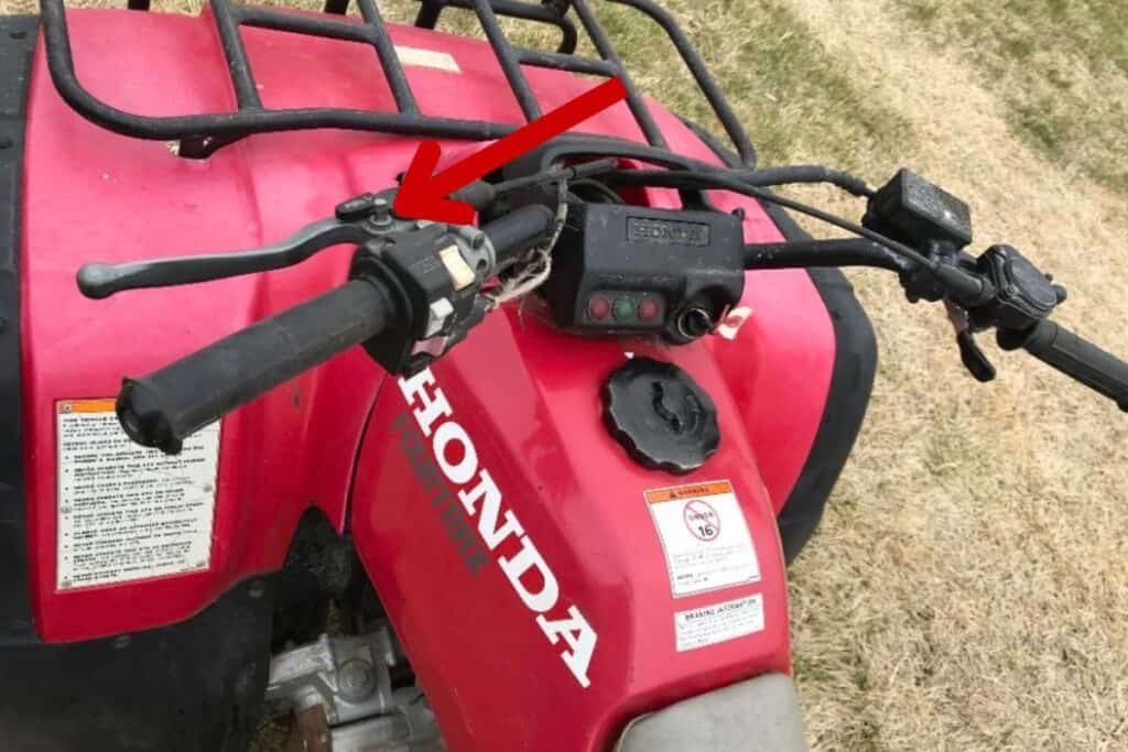 Honda Fourtrax 300 Handlebar Assembly with Arrow Pointing to the Reverse Button